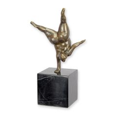Modernistisch bronzen beeld van balancerende vrouw op zwarte kubusvormige sokkel